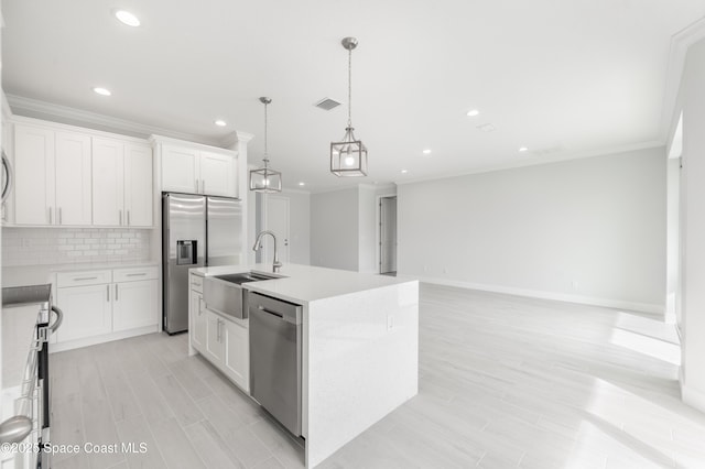 210 La Gore St, Palm Bay, FL 32908 - kitchen with stainless steel appliances, crown molding, decorative backsplash, an island with sink, and recessed lighting