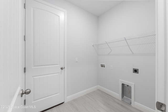 210 La Gore St, Palm Bay, FL 32908 - laundry area with hookup for an electric dryer, hookup for a washing machine, and light wood-style flooring