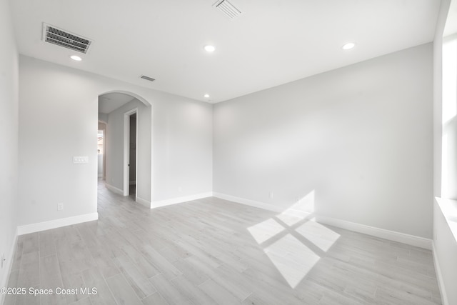 210 La Gore St, Palm Bay, FL 32908 - unfurnished room featuring arched walkways, light wood finished floors, and recessed lighting