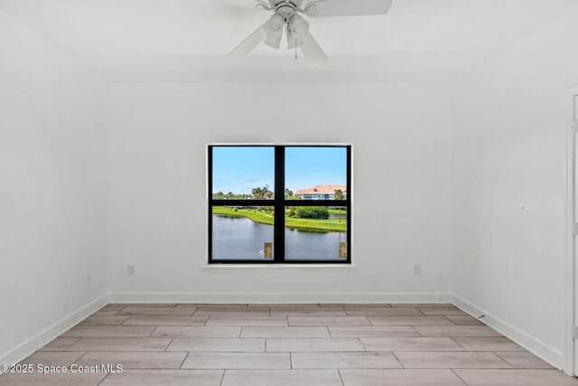6461 Borasco Dr Unit 3808, Melbourne, FL 32940 - empty room with wood tiled floors, a ceiling fan, and a water view