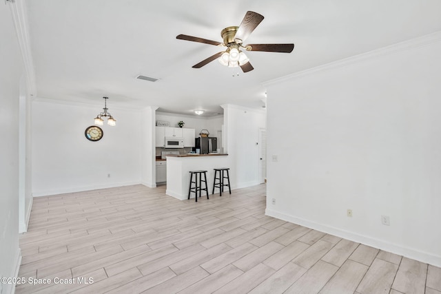 6461 Borasco Dr Unit 3808, Melbourne, FL 32940 - unfurnished living room with crown molding, a ceiling fan, light wood finished floors, and a chandelier