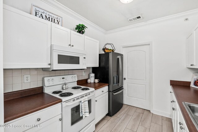 6461 Borasco Dr Unit 3808, Melbourne, FL 32940 - kitchen with white appliances, dark countertops, ornamental molding, and decorative backsplash