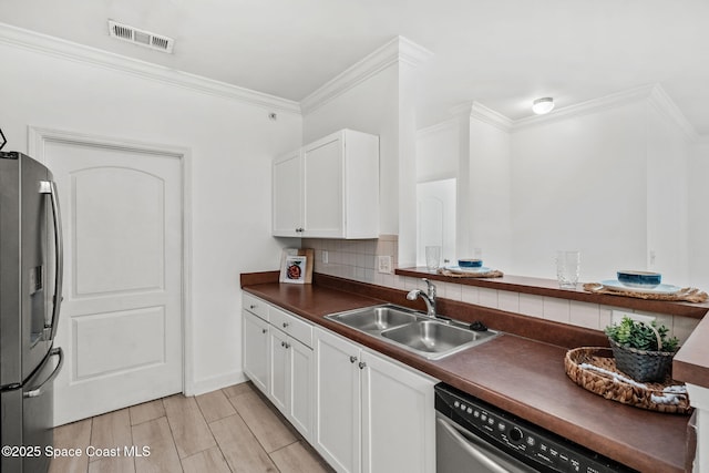 6461 Borasco Dr Unit 3808, Melbourne, FL 32940 - kitchen with stainless steel appliances, dark countertops, crown molding, tasteful backsplash, and white cabinets