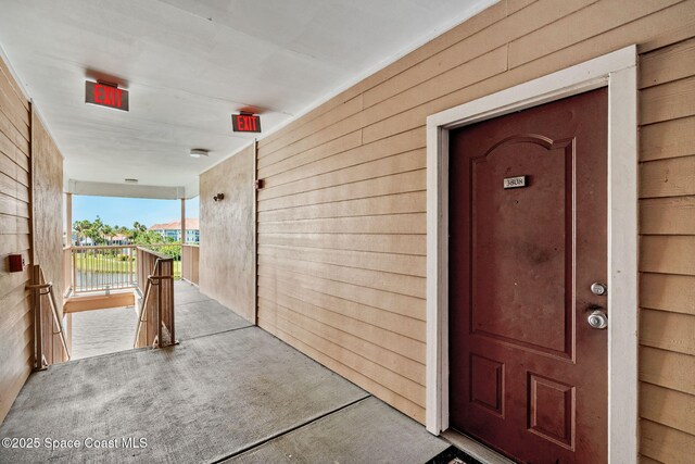 6461 Borasco Dr Unit 3808, Melbourne, FL 32940 - view of exterior entry featuring a balcony