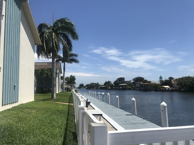 250 N Banana River Dr Unit F-11, Merritt Island, FL 32952 - dock area with a water view and a lawn