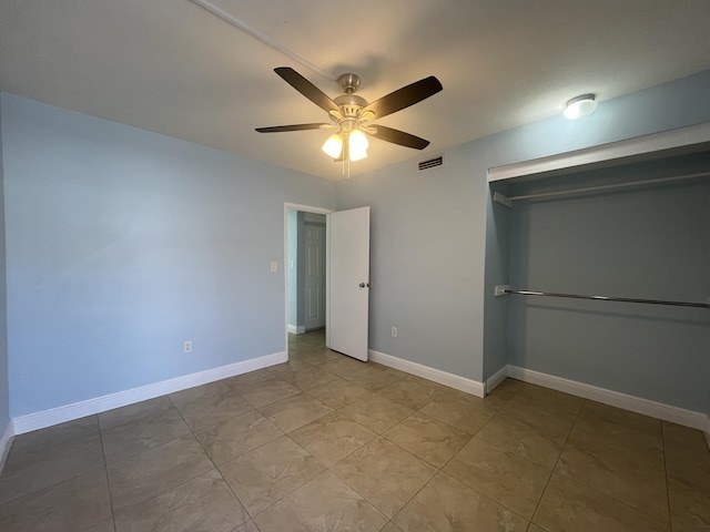 250 N Banana River Dr Unit F-11, Merritt Island, FL 32952 - unfurnished bedroom featuring a closet, ceiling fan, and tile patterned flooring