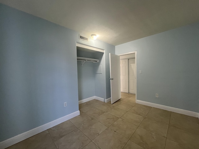 250 N Banana River Dr Unit F-11, Merritt Island, FL 32952 - unfurnished bedroom with a closet and light tile patterned flooring