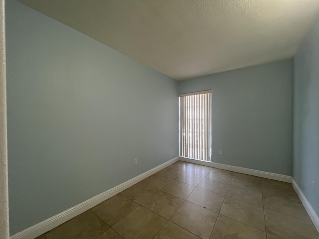 250 N Banana River Dr Unit F-11, Merritt Island, FL 32952 - tiled spare room with baseboards