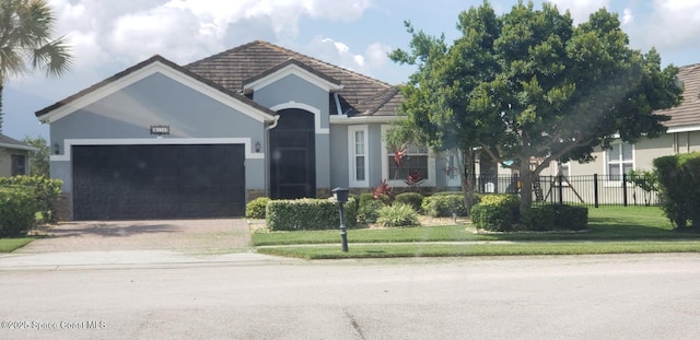 6115 Trieda Dr, Melbourne, FL 32940 - ranch-style home with a garage, driveway, stucco siding, and a tiled roof