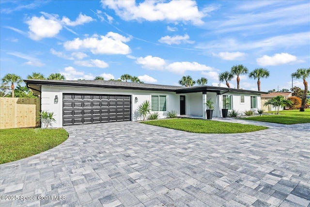 300 Oak St, Melbourne Beach, FL 32951 - view of front of home with decorative driveway, an attached garage, and stucco siding