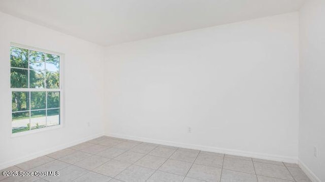 519 Gagnon St SE, Palm Bay, FL 32909 - spare room with baseboards and light tile patterned floors