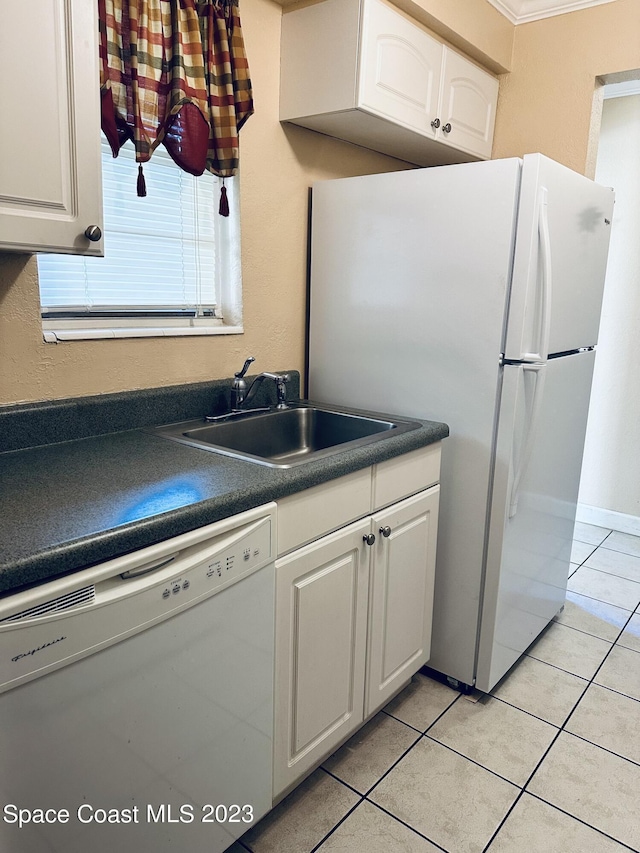 350 Taylor Ave Unit 11B2, Cape Canaveral, FL 32920 - kitchen with white appliances, dark countertops, white cabinets, and light tile patterned flooring