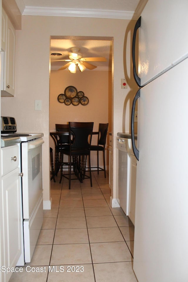350 Taylor Ave Unit 11B2, Cape Canaveral, FL 32920 - kitchen with white appliances, light tile patterned flooring, white cabinetry, crown molding, and a ceiling fan