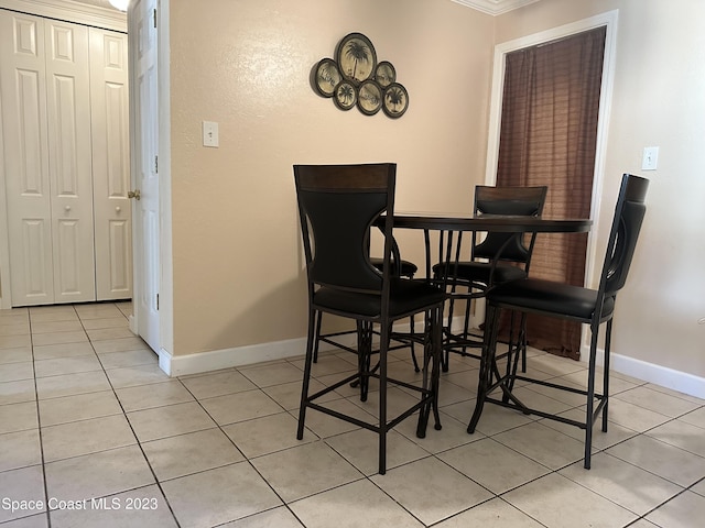 350 Taylor Ave Unit 11B2, Cape Canaveral, FL 32920 - dining space with light tile patterned floors and ornamental molding
