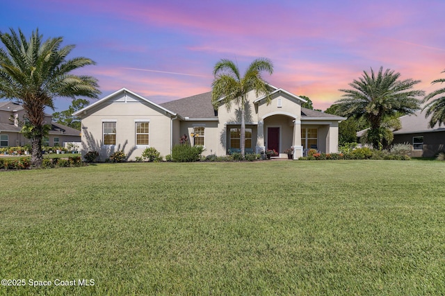 4014 Preservation Cir, Melbourne, FL 32934 - view of front of home featuring stucco siding and a yard