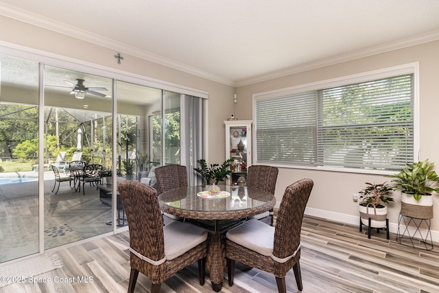 4014 Preservation Cir, Melbourne, FL 32934 - dining area with a ceiling fan, a sunroom, ornamental molding, and light wood-type flooring