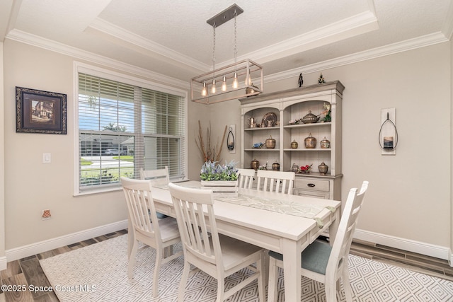 4014 Preservation Cir, Melbourne, FL 32934 - dining room with wood finished floors, crown molding, and a chandelier