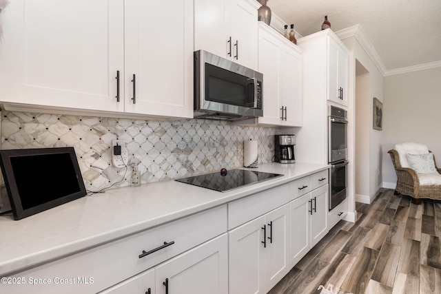 4014 Preservation Cir, Melbourne, FL 32934 - kitchen featuring appliances with stainless steel finishes, crown molding, dark wood-style flooring, light countertops, and white cabinets