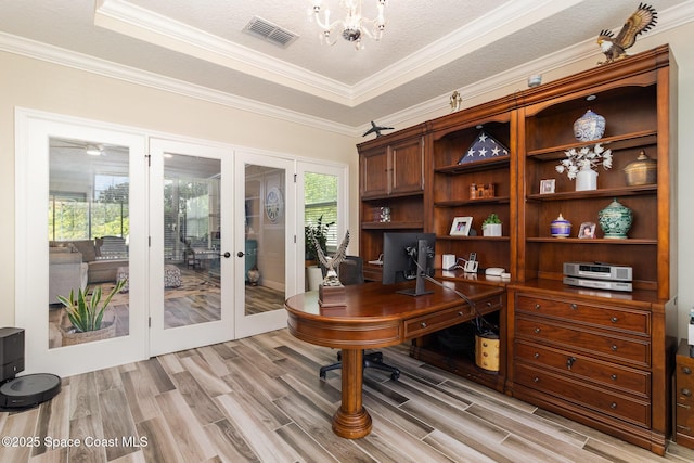 4014 Preservation Cir, Melbourne, FL 32934 - office featuring light wood-style floors, french doors, a raised ceiling, a chandelier, and crown molding