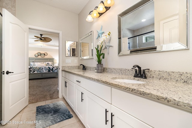 4014 Preservation Cir, Melbourne, FL 32934 - ensuite bathroom with double vanity, tile patterned floors, and a ceiling fan