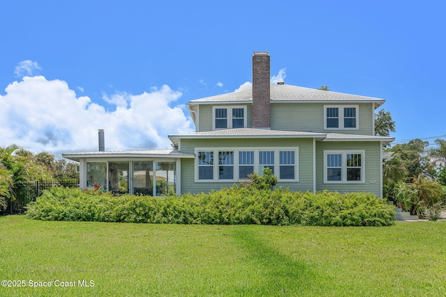 2907 N Indian River Dr, Cocoa, FL 32922 - back of house featuring a chimney and a sunroom