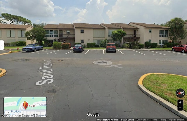 2601 Sand Trap Ln Unit 9-D, Melbourne, FL 32935 - uncovered parking lot featuring a residential view