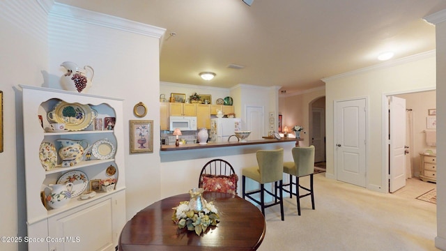 6461 Borasco Dr Unit 1805, Melbourne, FL 32940 - kitchen with white appliances, arched walkways, ornamental molding, light colored carpet, and a kitchen breakfast bar