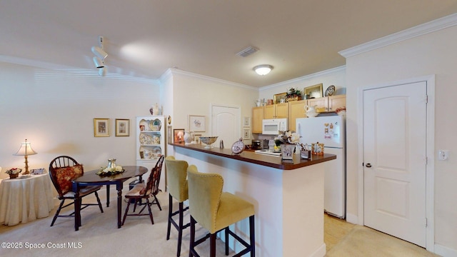 6461 Borasco Dr Unit 1805, Melbourne, FL 32940 - kitchen with white appliances, dark countertops, ornamental molding, a kitchen breakfast bar, and a peninsula