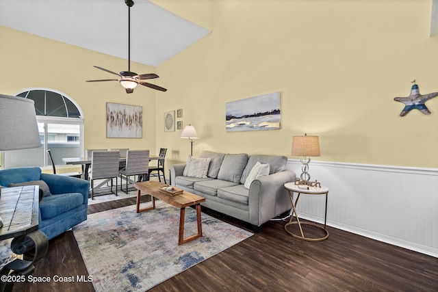 8600 Ridgewood Ave Unit 1311, Cape Canaveral, FL 32920 - living room featuring wood finished floors, a wainscoted wall, ceiling fan, and a towering ceiling