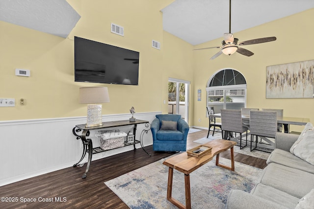 8600 Ridgewood Ave Unit 1311, Cape Canaveral, FL 32920 - living area featuring wood finished floors, a ceiling fan, a wainscoted wall, and a high ceiling