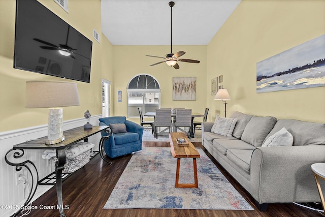 8600 Ridgewood Ave Unit 1311, Cape Canaveral, FL 32920 - living area with a ceiling fan, wood finished floors, a wainscoted wall, and a towering ceiling