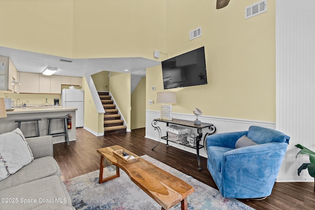 8600 Ridgewood Ave Unit 1311, Cape Canaveral, FL 32920 - living room with dark wood-type flooring, stairway, and wainscoting