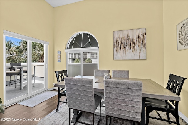 8600 Ridgewood Ave Unit 1311, Cape Canaveral, FL 32920 - dining space featuring wood finished floors and a towering ceiling