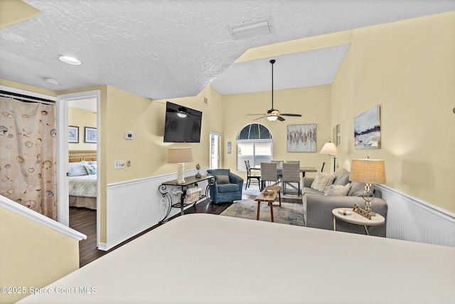 8600 Ridgewood Ave Unit 1311, Cape Canaveral, FL 32920 - living room with a wainscoted wall, wood finished floors, ceiling fan, and a textured ceiling