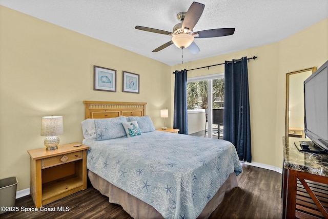 8600 Ridgewood Ave Unit 1311, Cape Canaveral, FL 32920 - bedroom featuring dark wood-style flooring, access to exterior, a textured ceiling, and a ceiling fan