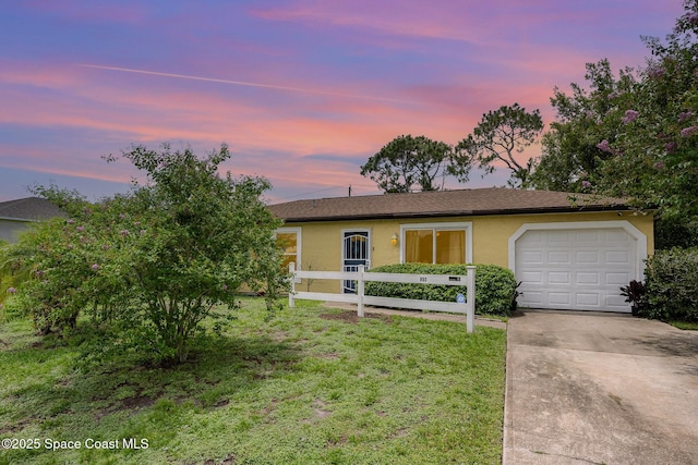 957 Stage St SE, Palm Bay, FL 32909 - single story home with driveway, stucco siding, an attached garage, and a front lawn