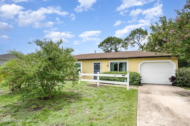 957 Stage St SE, Palm Bay, FL 32909 - single story home with stucco siding, concrete driveway, an attached garage, and a front lawn
