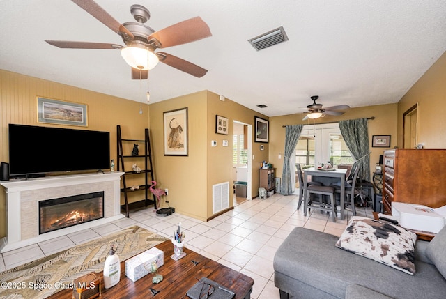 957 Stage St SE, Palm Bay, FL 32909 - living room with ceiling fan, light tile patterned floors, and a fireplace