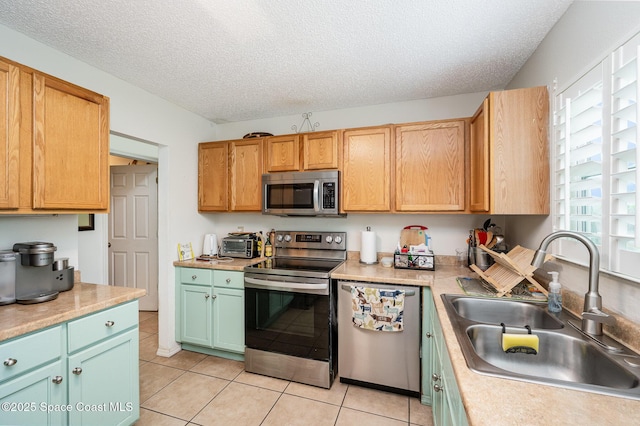 957 Stage St SE, Palm Bay, FL 32909 - kitchen with appliances with stainless steel finishes, light tile patterned floors, a textured ceiling, and light countertops