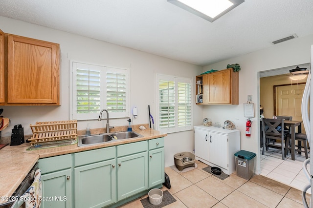 957 Stage St SE, Palm Bay, FL 32909 - kitchen featuring light countertops, light tile patterned flooring, and dishwasher