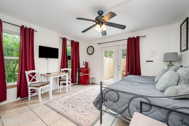 957 Stage St SE, Palm Bay, FL 32909 - bedroom featuring french doors, access to outside, multiple windows, tile patterned floors, and a textured ceiling