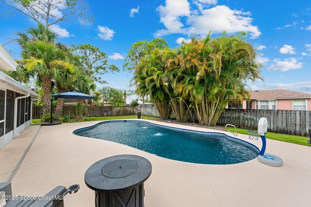 416 Catalina Ave NW, Palm Bay, FL 32907 - view of pool featuring a sunroom, a patio, and a fenced backyard