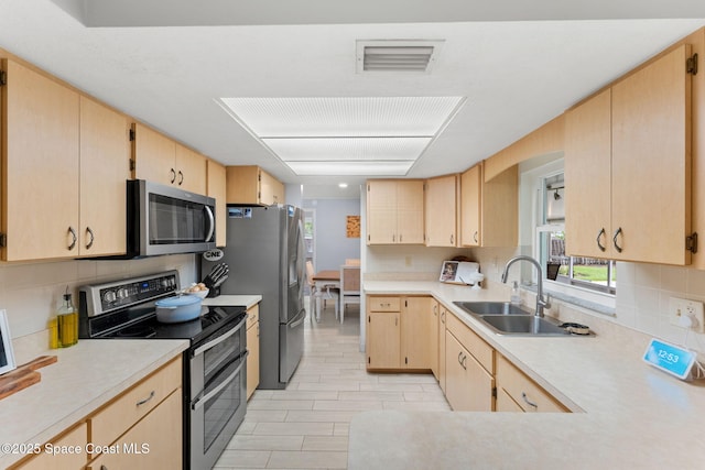 416 Catalina Ave NW, Palm Bay, FL 32907 - kitchen with stainless steel appliances and light brown cabinetry