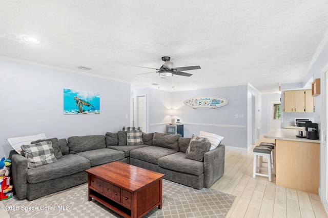 416 Catalina Ave NW, Palm Bay, FL 32907 - living room with light wood finished floors, a textured ceiling, a ceiling fan, and crown molding