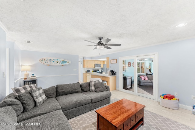 416 Catalina Ave NW, Palm Bay, FL 32907 - living room featuring crown molding, a ceiling fan, light wood-type flooring, and a textured ceiling