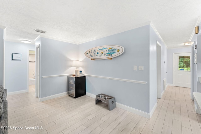 416 Catalina Ave NW, Palm Bay, FL 32907 - hallway with a textured ceiling, light wood-style flooring, and ornamental molding