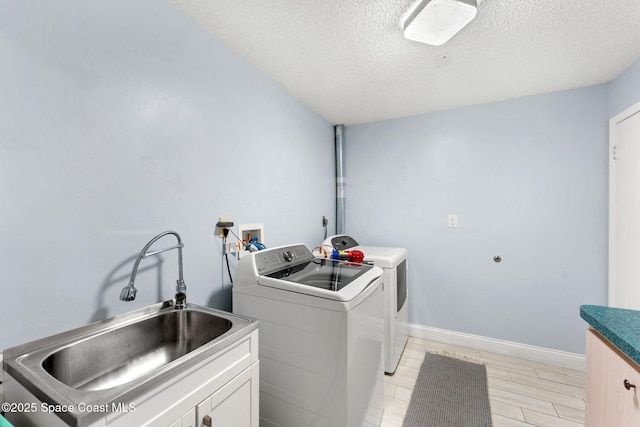 416 Catalina Ave NW, Palm Bay, FL 32907 - laundry area with washer and dryer, cabinet space, and a textured ceiling