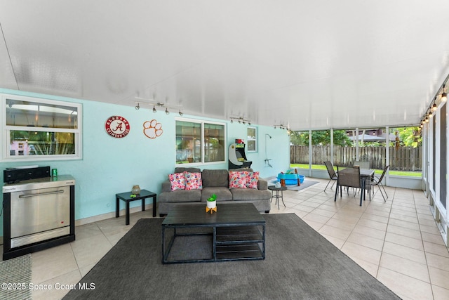 416 Catalina Ave NW, Palm Bay, FL 32907 - tiled living room featuring rail lighting and a sunroom