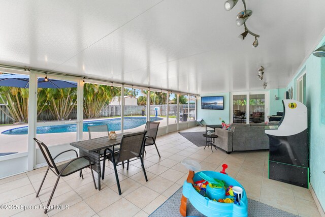 416 Catalina Ave NW, Palm Bay, FL 32907 - sunroom featuring tile patterned flooring and rail lighting