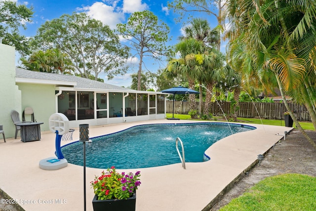 416 Catalina Ave NW, Palm Bay, FL 32907 - view of swimming pool with a sunroom, a fenced backyard, and a patio area